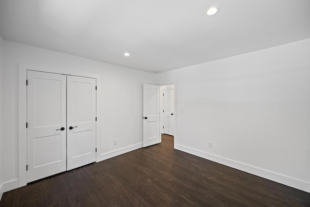 10 Shinnecock Ln, Hampton Bays, NY 11946 - unfurnished bedroom featuring baseboards, dark wood finished floors, recessed lighting, and a closet