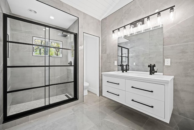 10 Shinnecock Ln, Hampton Bays, NY 11946 - full bathroom featuring tile walls, a shower stall, marble tiled flooring, toilet, and double vanity