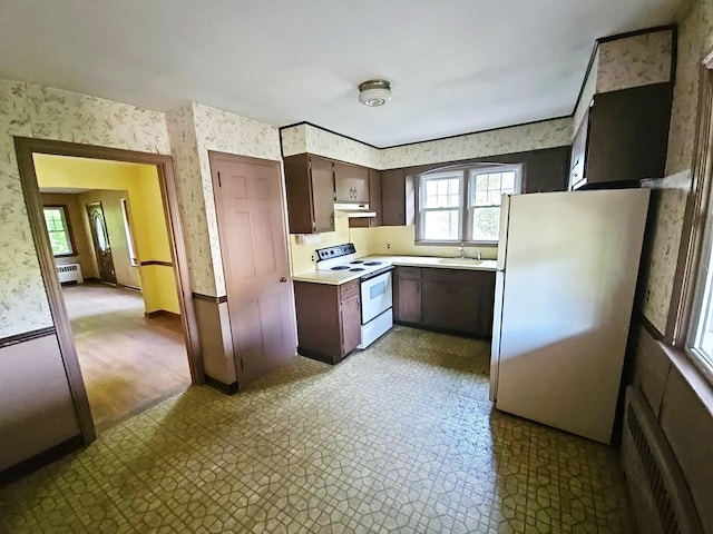 233 Peaceable Hill Rd, Brewster, NY 10509 - kitchen with white appliances, wallpapered walls, radiator, light countertops, and tile patterned floors