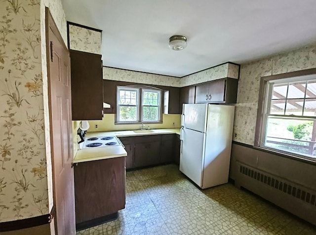 233 Peaceable Hill Rd, Brewster, NY 10509 - kitchen featuring white appliances, wallpapered walls, a sink, light countertops, and light flooring