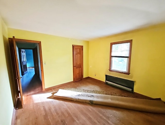 233 Peaceable Hill Rd, Brewster, NY 10509 - unfurnished living room with wood finished floors, baseboards, and radiator