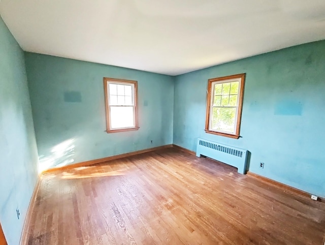 233 Peaceable Hill Rd, Brewster, NY 10509 - empty room featuring radiator heating unit, healthy amount of natural light, wood finished floors, and baseboards