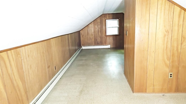 233 Peaceable Hill Rd, Brewster, NY 10509 - additional living space featuring vaulted ceiling, a baseboard heating unit, wooden walls, a baseboard radiator, and concrete floors