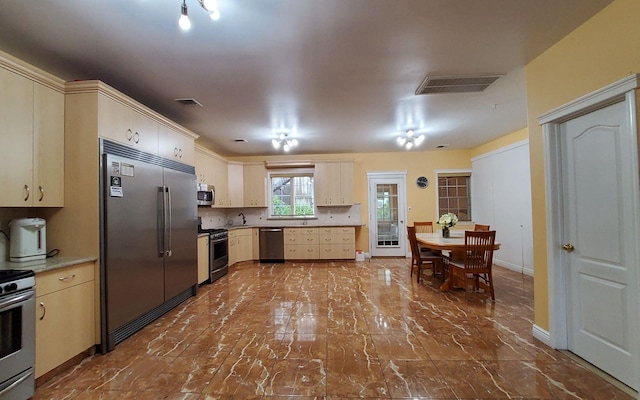 8 Lemberg Ct Unit 302, Monroe, NY 10950 - kitchen with stainless steel appliances, dark marble finish floors, baseboards, cream cabinets, and light countertops