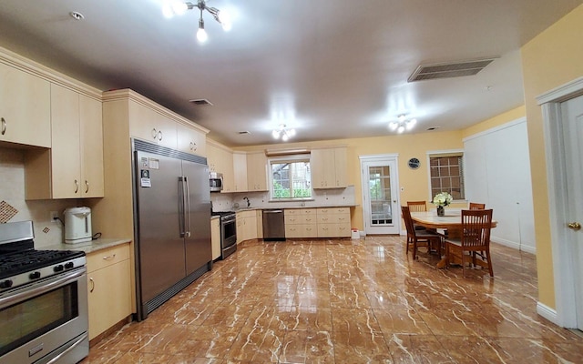 8 Lemberg Ct Unit 302, Monroe, NY 10950 - kitchen with appliances with stainless steel finishes, baseboards, marble finish flooring, light countertops, and cream cabinets