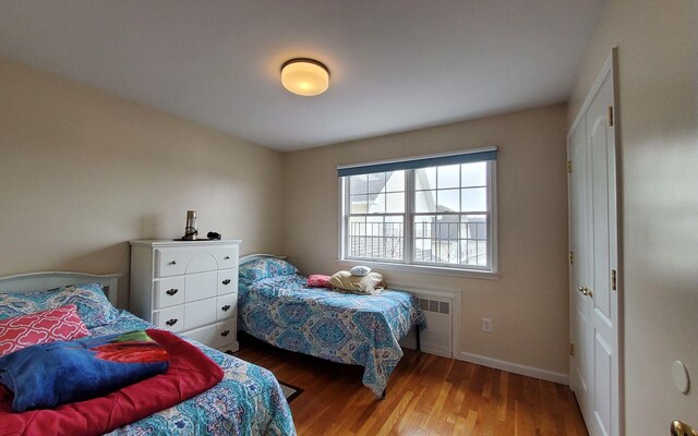 8 Lemberg Ct Unit 302, Monroe, NY 10950 - bedroom with radiator, wood finished floors, and baseboards