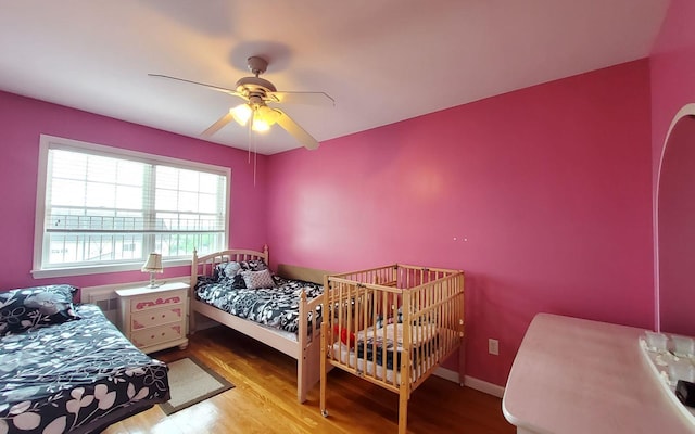 8 Lemberg Ct Unit 302, Monroe, NY 10950 - bedroom featuring wood finished floors, ceiling fan, and arched walkways