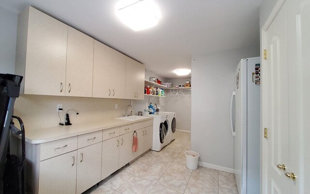 8 Lemberg Ct Unit 302, Monroe, NY 10950 - washroom featuring washer and clothes dryer, light tile patterned floors, baseboards, and cabinet space