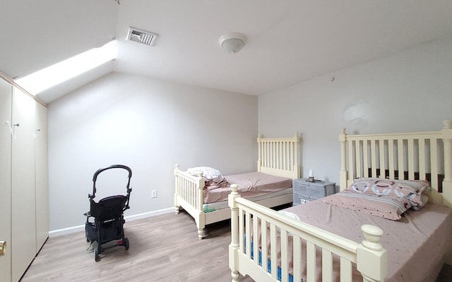 8 Lemberg Ct Unit 302, Monroe, NY 10950 - bedroom with wood finished floors, baseboards, lofted ceiling, and a skylight