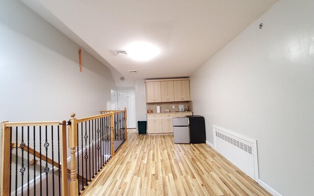 8 Lemberg Ct Unit 302, Monroe, NY 10950 - corridor with radiator heating unit, light wood finished floors, an upstairs landing, and baseboards