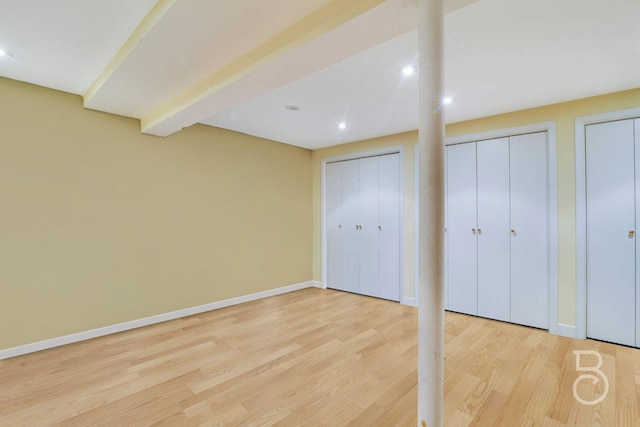 20-21 48th St, Astoria, NY 11105 - unfurnished bedroom with light wood-type flooring, two closets, baseboards, and recessed lighting