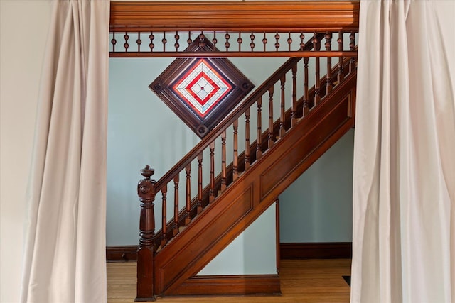 604 Main St, Greenport, NY 11944 - stairway featuring wood finished floors and baseboards