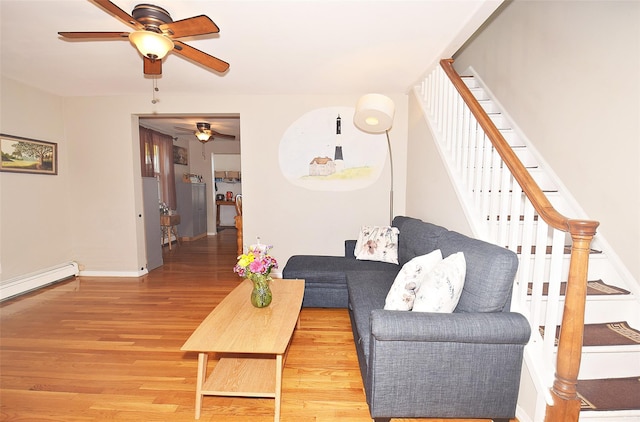 living area with ceiling fan, stairs, wood finished floors, and baseboards