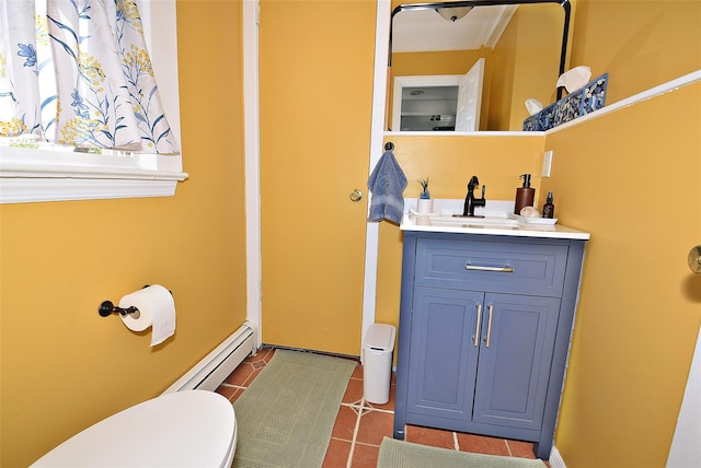 bathroom with baseboard heating, toilet, vanity, and tile patterned floors