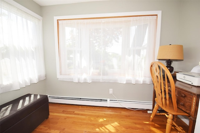 office space featuring baseboard heating and wood finished floors
