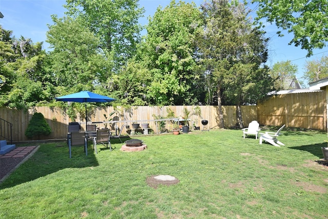view of yard with a fire pit