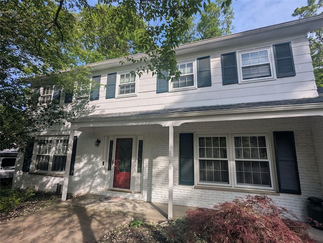 view of front of property featuring a porch and brick siding