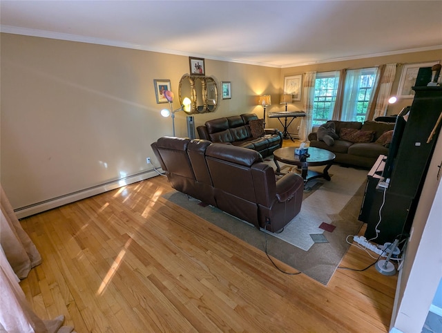 living area featuring wood finished floors, baseboard heating, crown molding, and baseboards