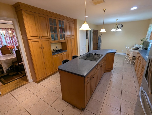 kitchen with a chandelier, black electric cooktop, dark countertops, a kitchen island, and recessed lighting