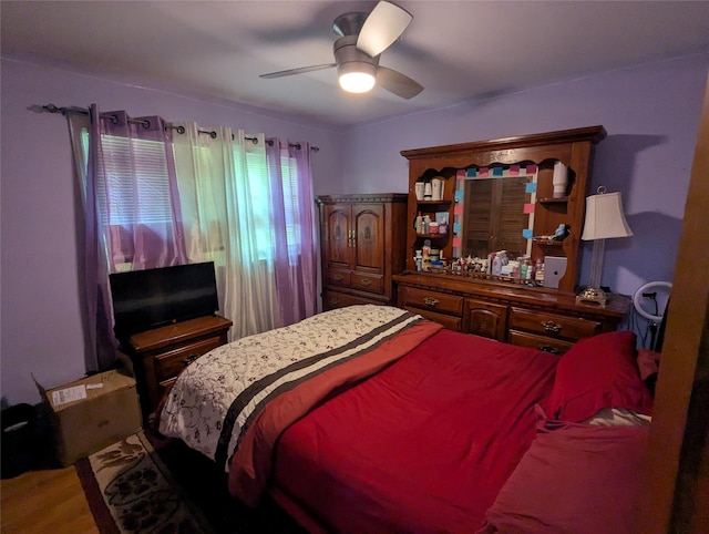 bedroom with wood finished floors and a ceiling fan