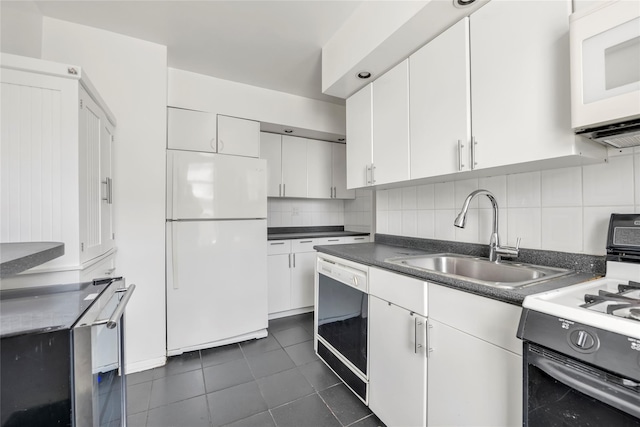 100-25 Queens Blvd Unit 6E, Forest Hills, NY 11375 - kitchen featuring white appliances, a sink, dark tile patterned flooring, white cabinetry, and tasteful backsplash