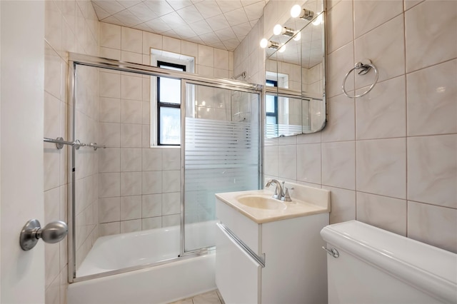 100-25 Queens Blvd Unit 6E, Forest Hills, NY 11375 - bathroom featuring tile walls, toilet, bath / shower combo with glass door, and vanity