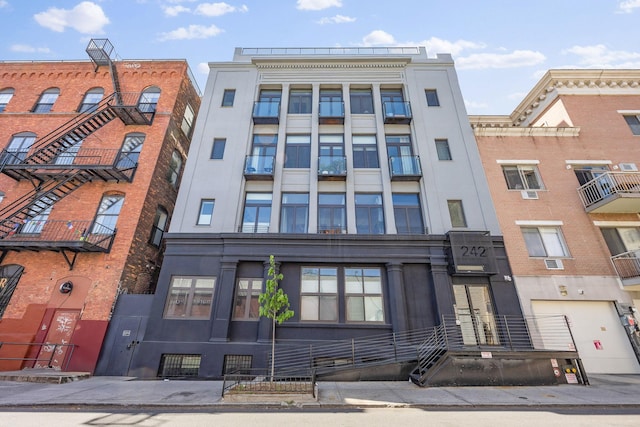 242 S 1st St Unit 1D, Brooklyn, NY 11211 - view of apartment building / complex featuring a garage