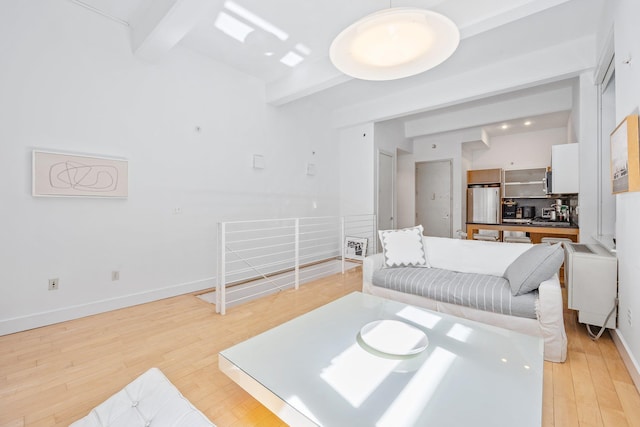 242 S 1st St Unit 1D, Brooklyn, NY 11211 - living area featuring beamed ceiling, light wood-style flooring, and baseboards