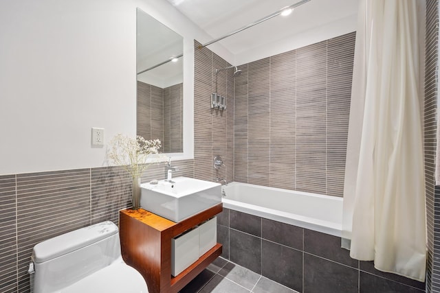 242 S 1st St Unit 1D, Brooklyn, NY 11211 - full bath featuring tile walls, tiled shower / bath, tile patterned floors, toilet, and vanity