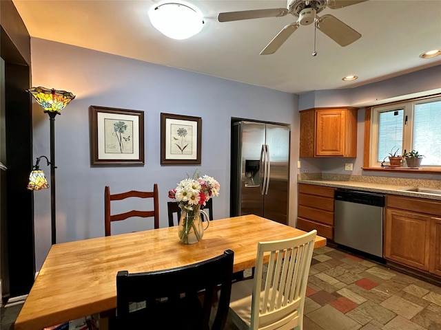 kitchen with appliances with stainless steel finishes, brown cabinets, recessed lighting, wooden counters, and a sink