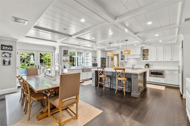 dining space featuring recessed lighting, dark wood-style floors, french doors, healthy amount of natural light, and beam ceiling