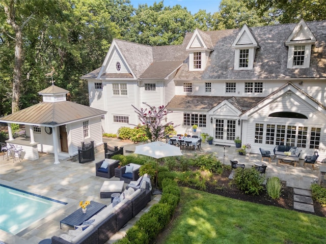 back of house with an outdoor hangout area, french doors, a patio, a yard, and central AC