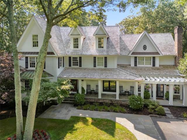 view of front of home featuring a high end roof and a chimney