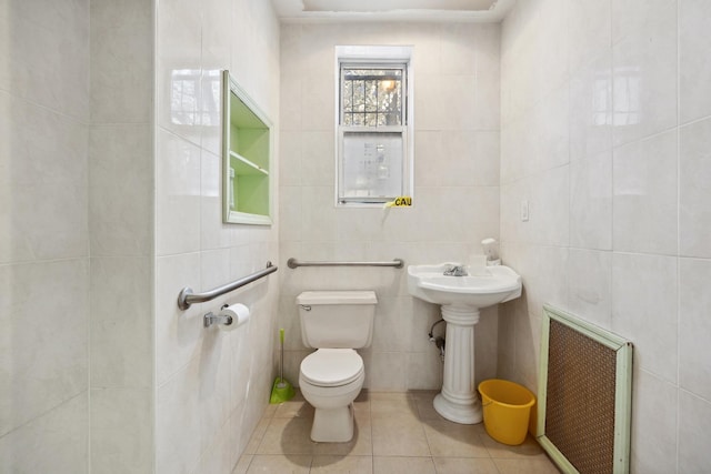 42-06 66th St, Woodside, NY 11377 - half bathroom with tile walls, toilet, tile patterned floors, and a sink