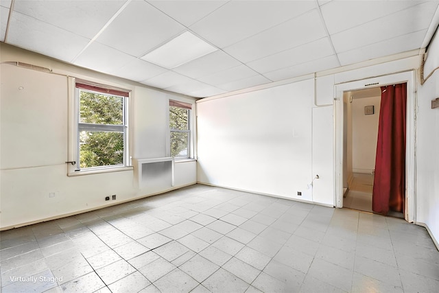 42-06 66th St, Woodside, NY 11377 - tiled spare room featuring baseboards and a drop ceiling