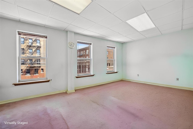 42-06 66th St, Woodside, NY 11377 - carpeted spare room with a paneled ceiling and baseboards