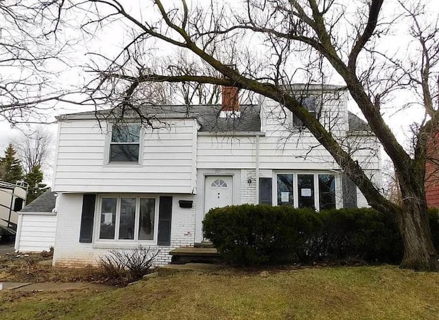 321 Niagara Falls Blvd, Call Listing Agent, NY 14226 - view of front of house featuring a chimney, brick siding, a garage, and a front yard