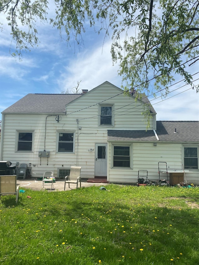 321 Niagara Falls Blvd, Call Listing Agent, NY 14226 - back of house with a patio area, a lawn, and a shingled roof