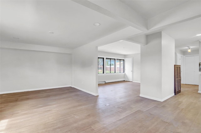 empty room with light wood-style floors, baseboards, and recessed lighting