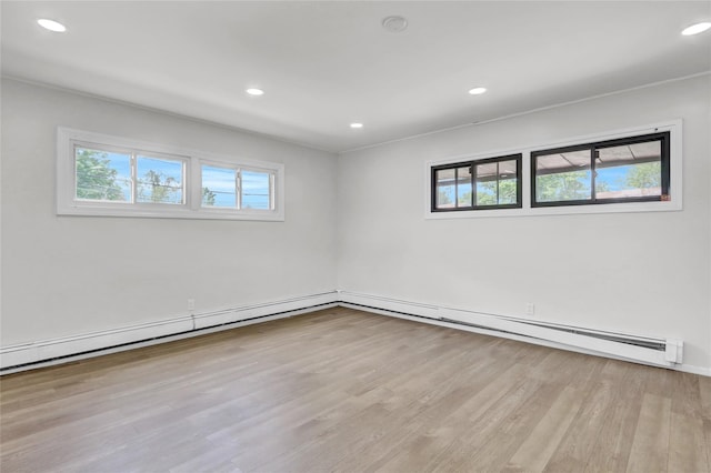unfurnished room featuring healthy amount of natural light, wood finished floors, and recessed lighting