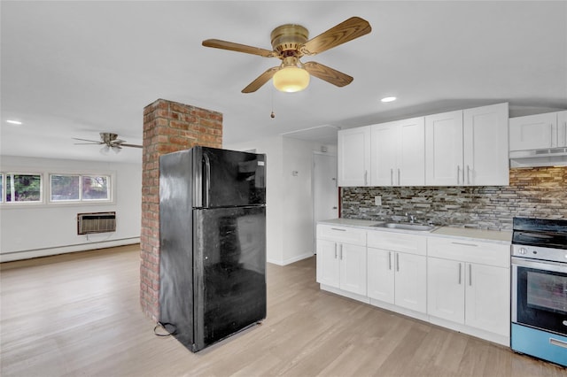 kitchen featuring freestanding refrigerator, electric range, ceiling fan, a sink, and a baseboard radiator