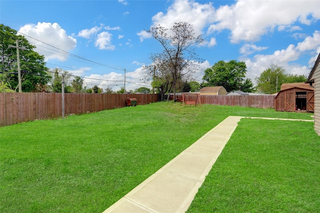 view of yard with a storage shed and an outbuilding