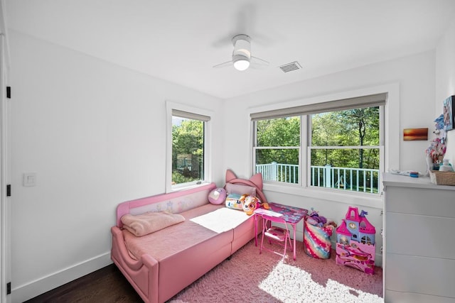 128 Priscilla Ave, Flanders, NY 11901 - bedroom featuring multiple windows, baseboards, ceiling fan, and wood finished floors