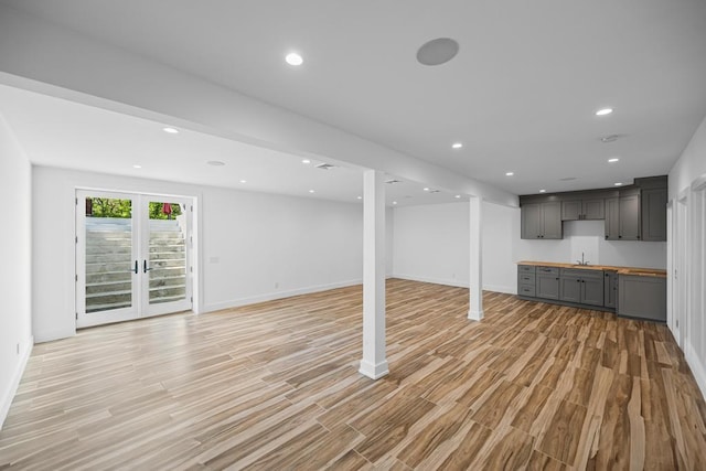 128 Priscilla Ave, Flanders, NY 11901 - unfurnished living room with light wood-style floors, baseboards, a sink, and recessed lighting