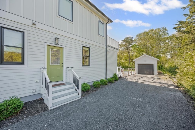 128 Priscilla Ave, Flanders, NY 11901 - view of side of property with board and batten siding, entry steps, a garage, and an outdoor structure