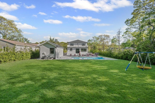 128 Priscilla Ave, Flanders, NY 11901 - rear view of property featuring a yard, a patio area, a balcony, and a playground