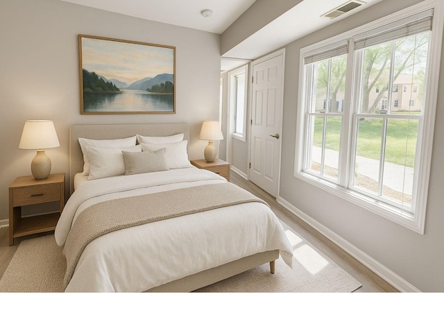 35 Navajo Ct Unit 35, Coram, NY 11727 - bedroom featuring baseboards, multiple windows, and light wood-style flooring