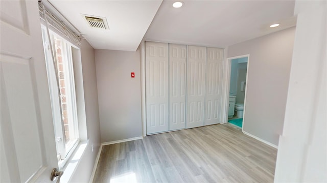 35 Navajo Ct Unit 35, Coram, NY 11727 - unfurnished bedroom featuring baseboards, light wood finished floors, a closet, connected bathroom, and recessed lighting