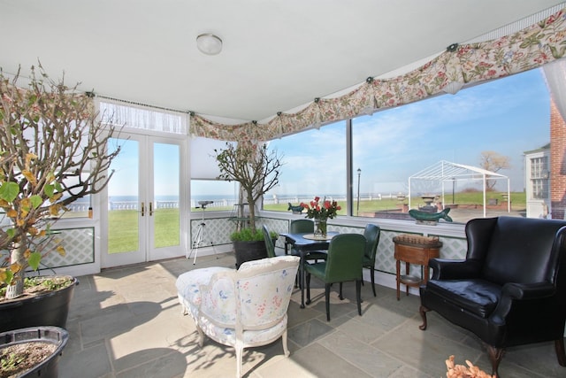 2 Wallis Ln, Nissequogue, NY 11780 - sunroom / solarium with french doors, stone tile flooring, and outdoor dining space