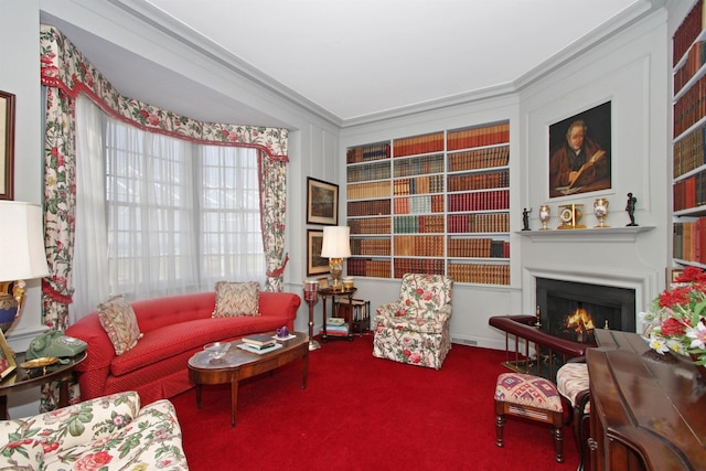 2 Wallis Ln, Nissequogue, NY 11780 - living area with a warm lit fireplace, carpet flooring, and ornamental molding